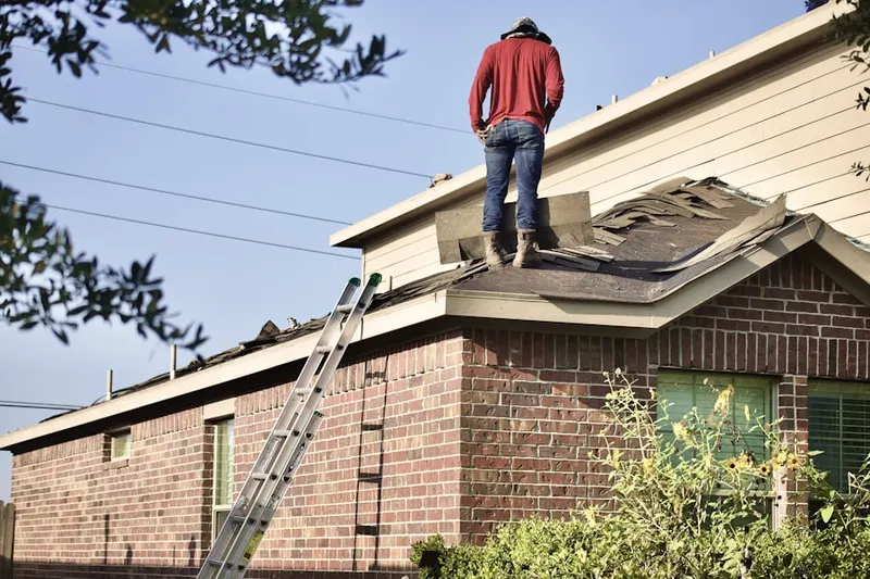 Professional roofer working on a residential roof in Hammville